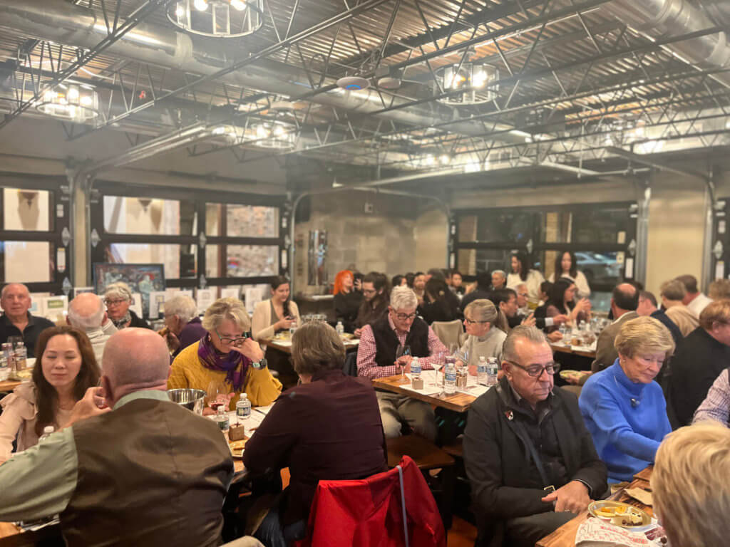 Guests at Bridges to Learning 2023 Wine Tasting sitting at tables. Supporting the education of impoverished children in Vietnam.