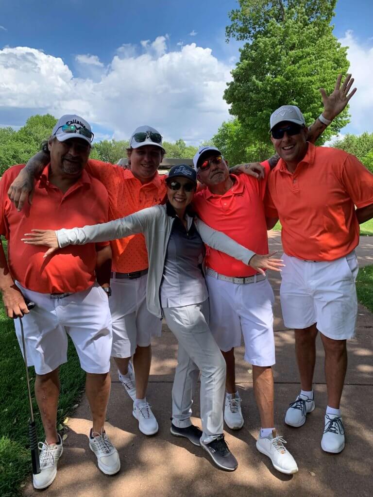 Bridges to Learning 3rd Annual Charity Tournament at The Wilds Golf Club, Prior Lake Minnesota. Four happy golfers from the Elite 8 team posing with event coordinator and board member Linh Phan by the course. At tournament to raise funds for schools for impoverished children in Vietnam.