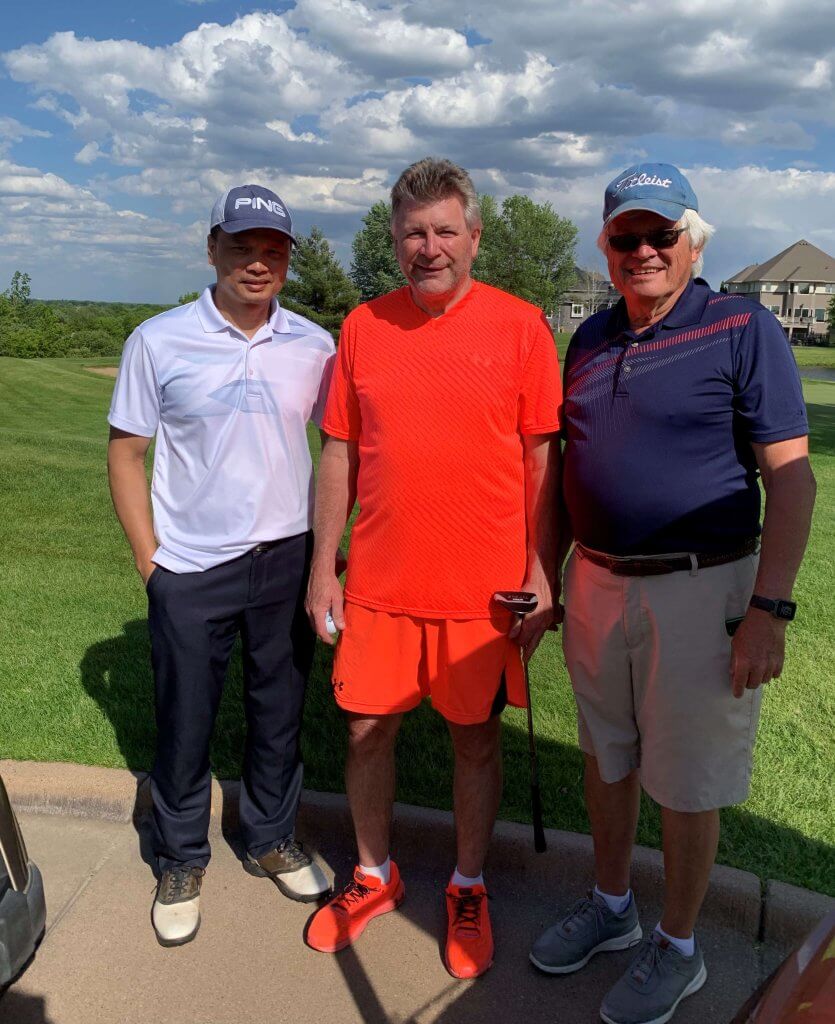 Bridges to Learning 3rd Annual Charity Tournament at The Wilds Golf Club, Prior Lake Minnesota. Three smiling men standing by the course. At tournament to raise funds for schools for impoverished children in Vietnam.