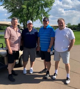 Four golfers pose for a picture at the 3rd annual Bridges to Learning Charity Golf Tournament at the Wilds Golf Course in Prior Lake Minnesota.