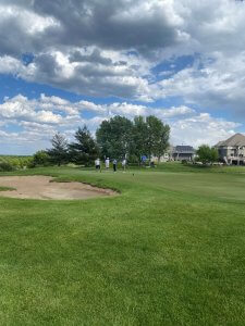 Pretty picture of the Wilds Golf Course in Minnesota with golfers in the distance. Raising funds to support poor children in Vietnam. Bridges to Learning Golf Tournament 2022.