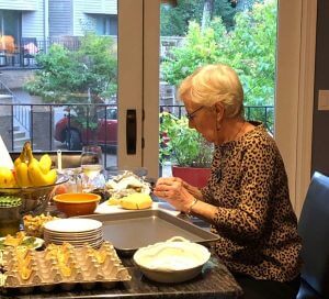 Volunteer Jerri Hirsch preparing food for Founders Dinner. Bridges to Learning.